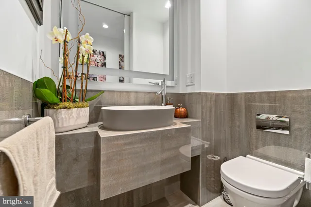 a white toilet sitting next to a bathroom sink