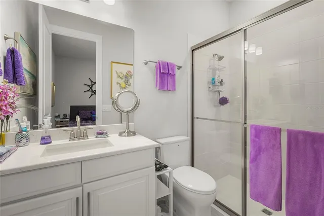 a bathroom with a sink vanity mirror and toilet