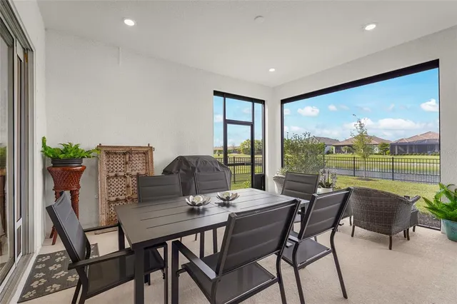 a view of a dining room with furniture wooden floor and garden view