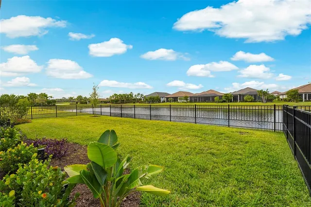 a view of a lake with houses in the back