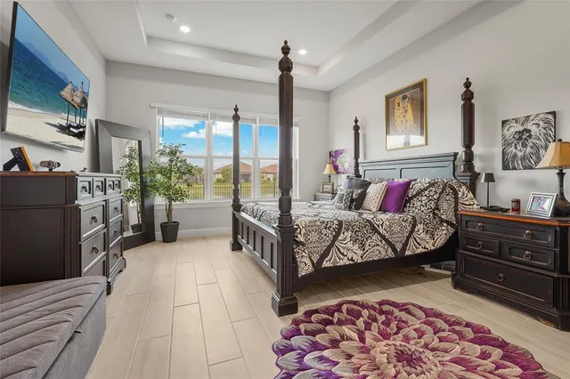 a bedroom with furniture and large windows