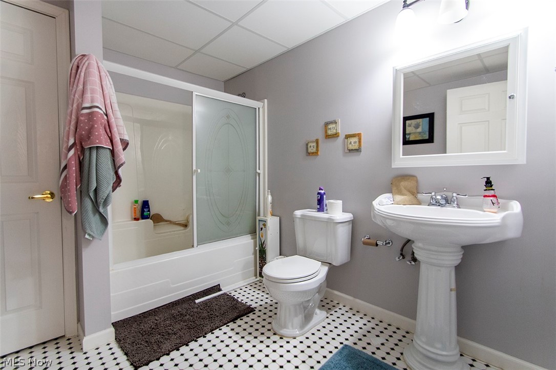 4902 Foote Road, Unit 21 Medina, OH 44256 - Photo 23 of 34 Bathroom with a paneled ceiling, enclosed tub / shower combo, toilet, and tile floors