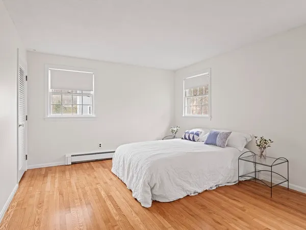 a bedroom with a bed and a wooden floor