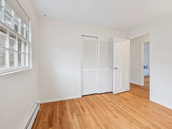 a view of an empty room with wooden floor