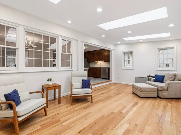 a living room with fireplace furniture and a wooden floor