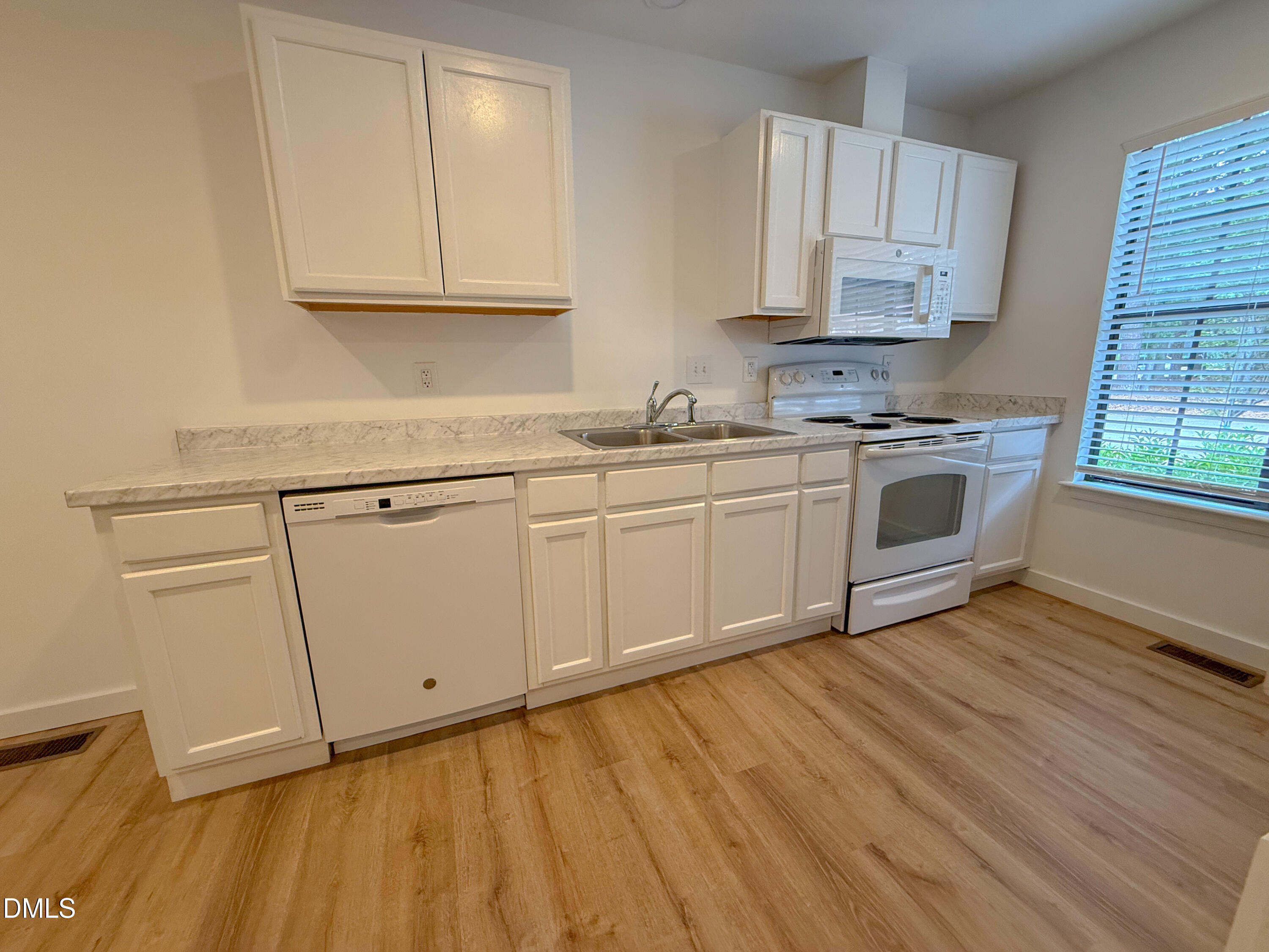 4247 The Oaks Drive Raleigh, NC 27606 - Photo 8 of 21 a kitchen with cabinets a sink and appliances