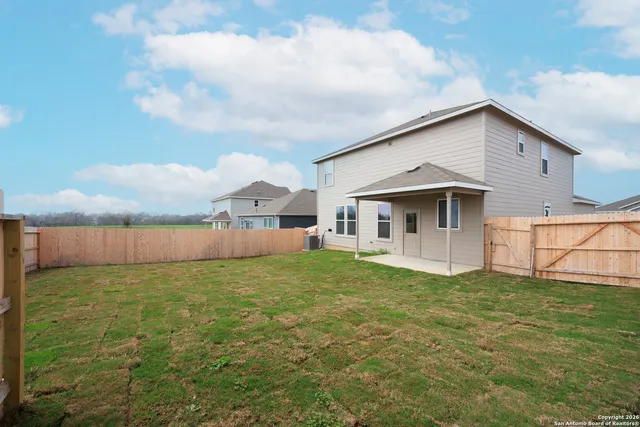 a view of a house with a yard and garage