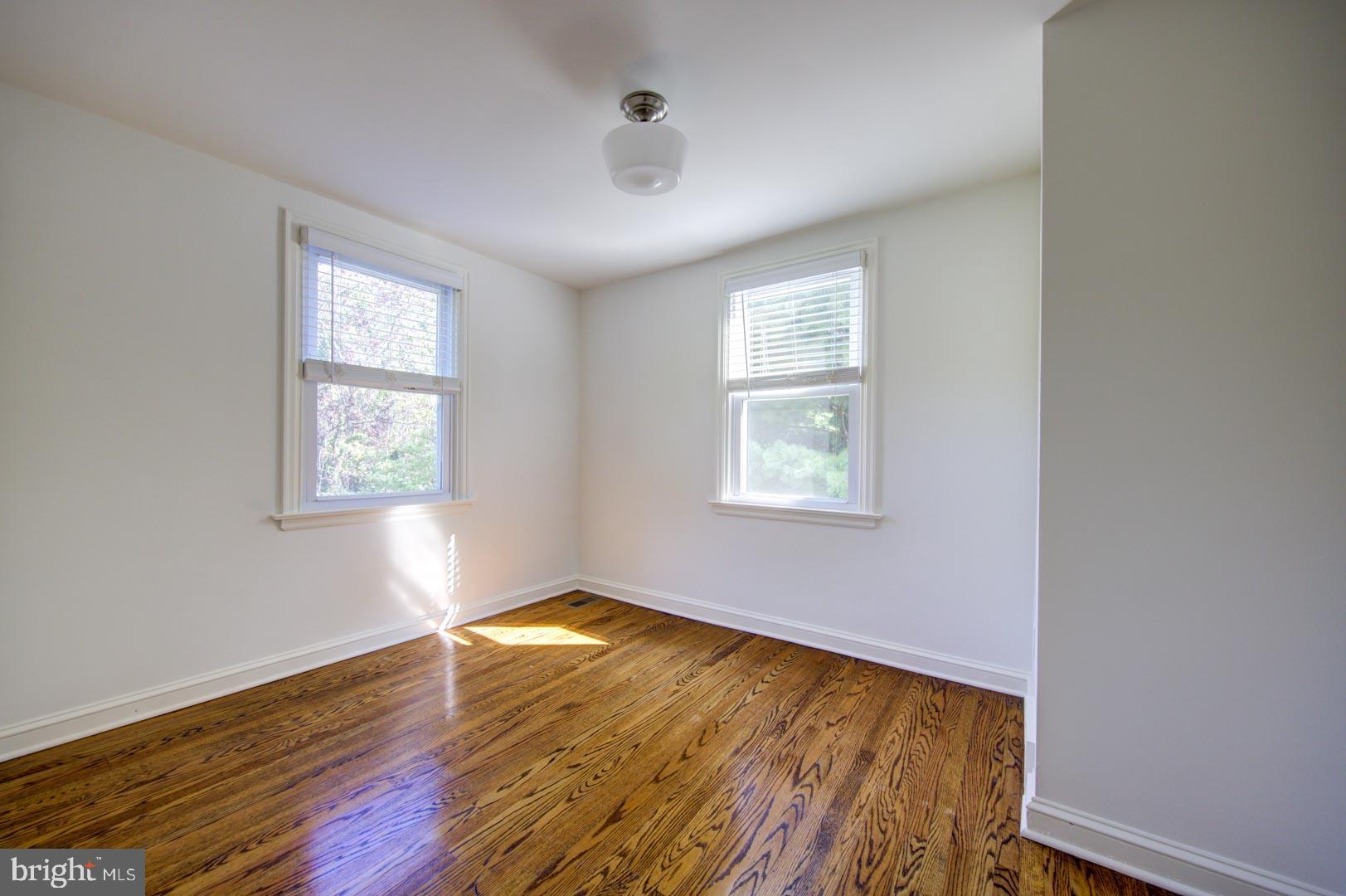 273 South Devon Avenue Wayne, PA 19087 - Photo 17 of 32 an empty room with wooden floor and windows