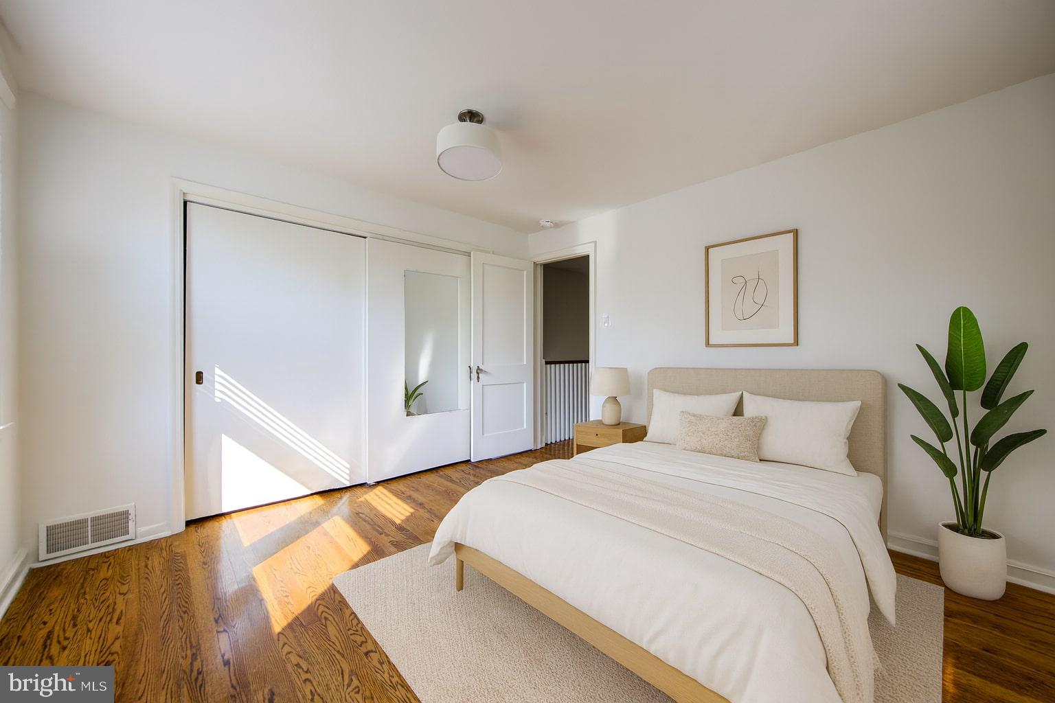 273 South Devon Avenue Wayne, PA 19087 - Photo 19 of 32 a bedroom with a large bed and a potted plant