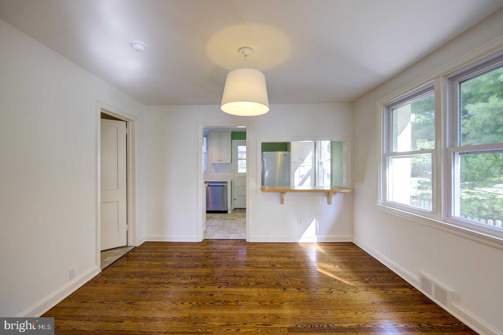 273 South Devon Avenue Wayne, PA 19087 - Photo 7 of 32 a view of an empty room with window and wooden floor