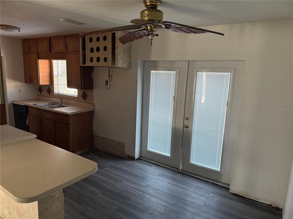 1129 Southwest Golden Avenue Arcadia, FL 34266 - Photo 12 of 25 a kitchen with stainless steel appliances granite countertop a refrigerator a sink dishwasher and a stove with wooden floor