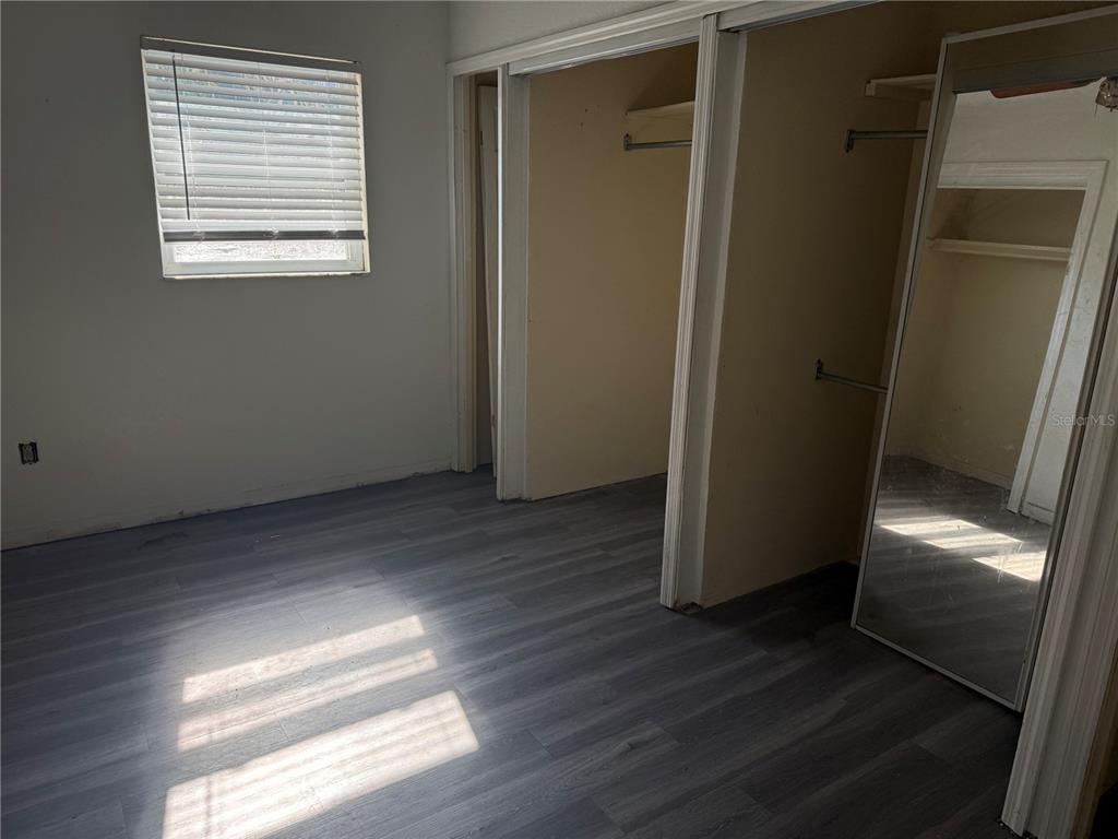 1129 Southwest Golden Avenue Arcadia, FL 34266 - Photo 18 of 25 a view of empty room with wooden floor and window