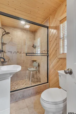 a bathroom with a toilet and a shower
