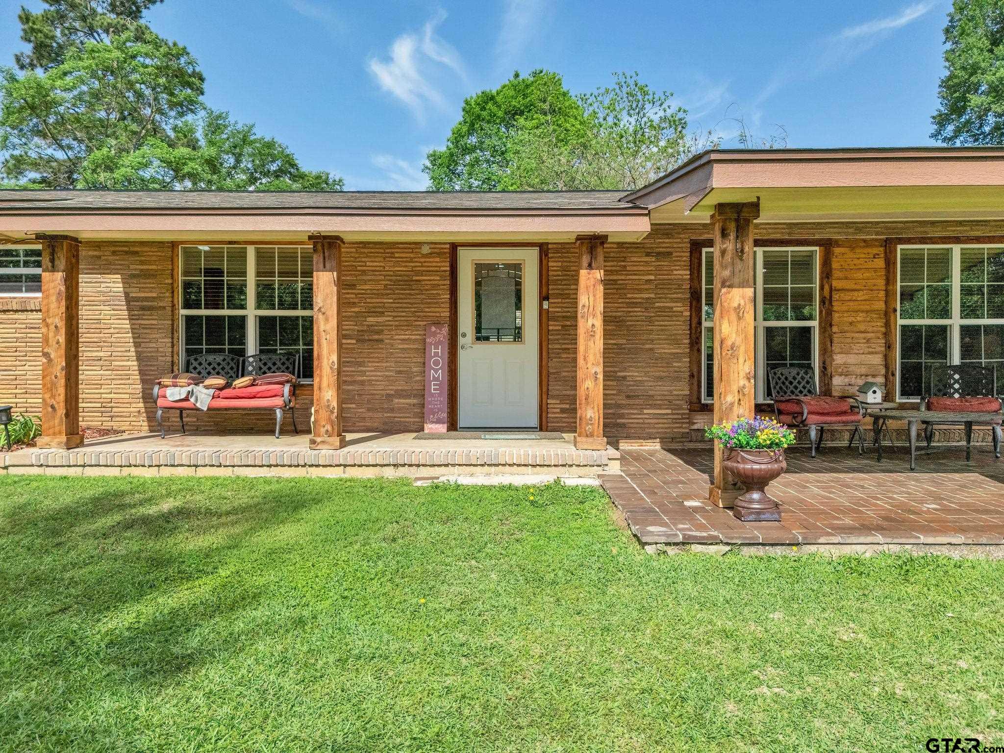519 E Well Naples, TX 75568 - Photo 2 of 48 a view of a house with backyard sitting area and porch