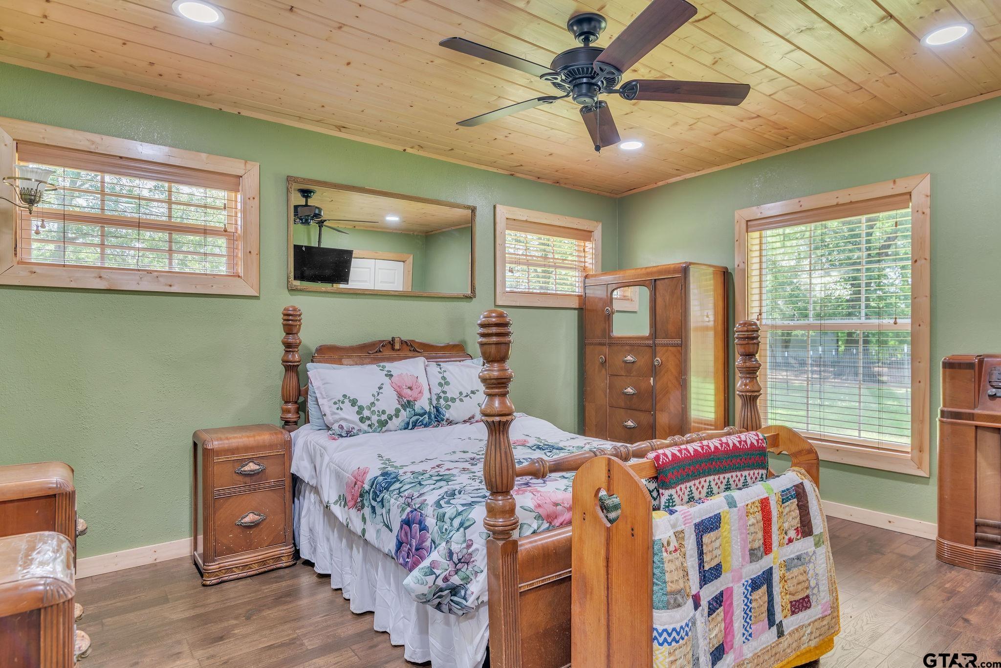 519 E Well Naples, TX 75568 - Photo 24 of 48 a bedroom with a large bed and a chandelier
