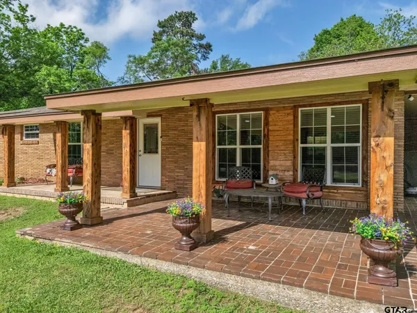a view of a house with sitting area and garden