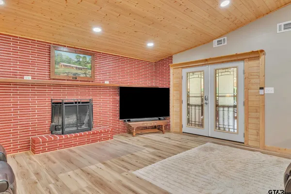 a bedroom with furniture and a flat screen tv