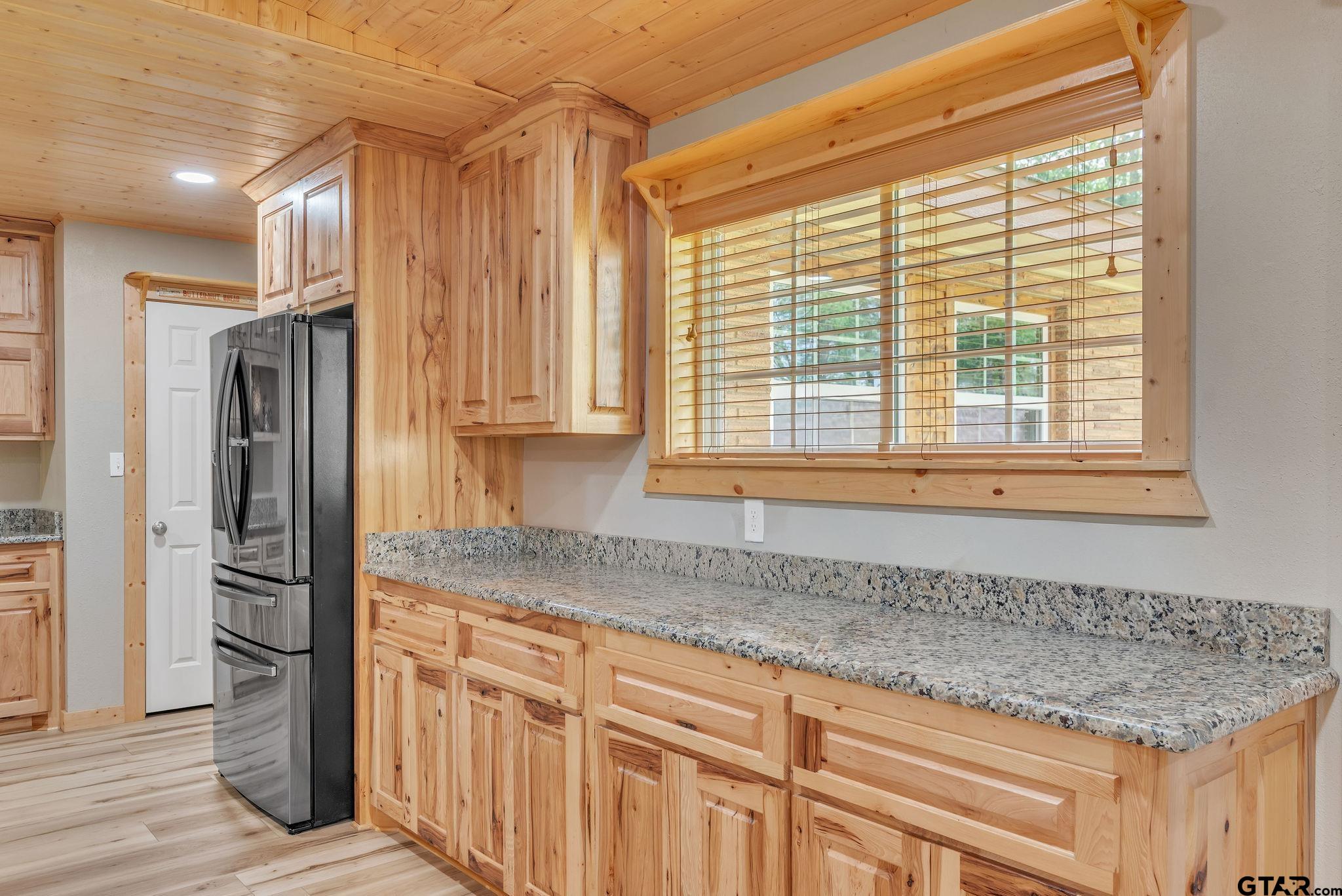519 E Well Naples, TX 75568 - Photo 10 of 48 a kitchen with stainless steel appliances granite countertop a refrigerator and a sink