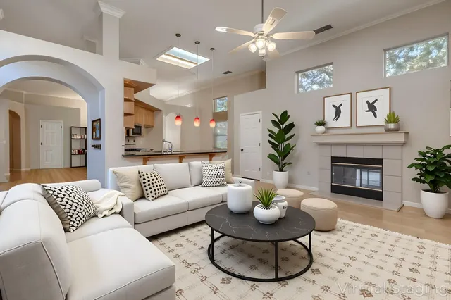 a living room with furniture a chandelier and a fireplace