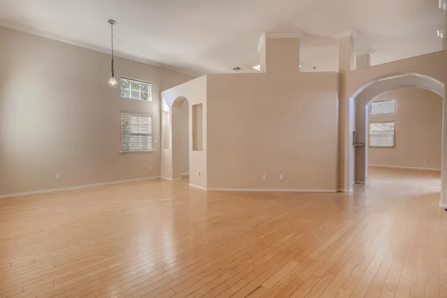 a view of a room with wooden floor and window
