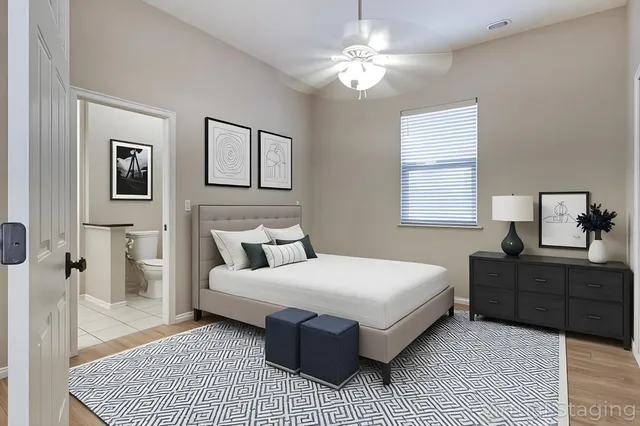 a bedroom with a large bed and a chandelier