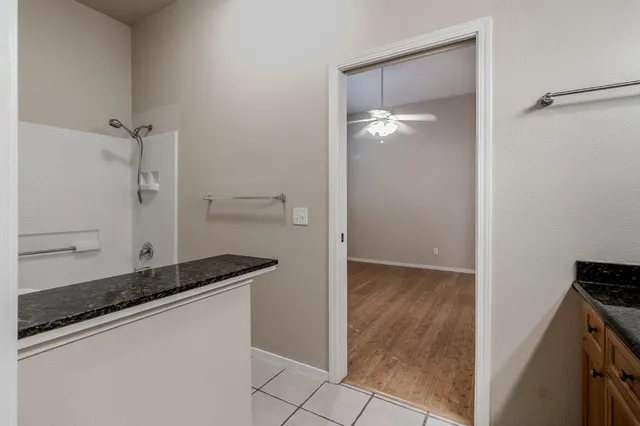 a bathroom with a granite countertop sink and a mirror
