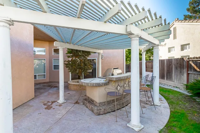 a view of a patio with table and chairs potted plants