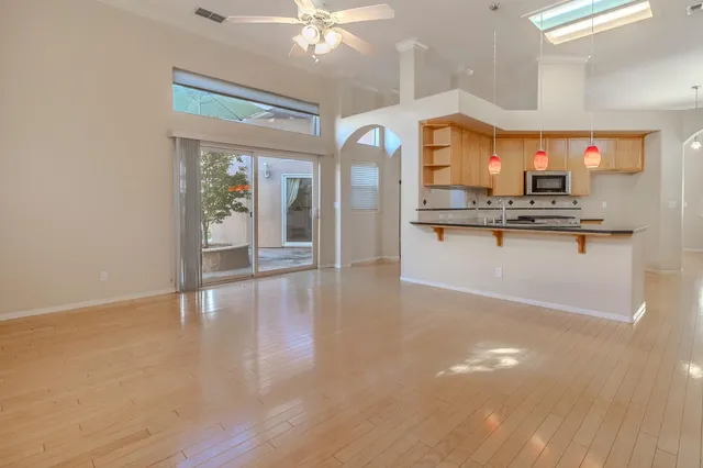 a view of a living room and kitchen with a large window