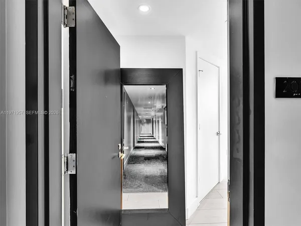 a hallway with a dining table and chairs