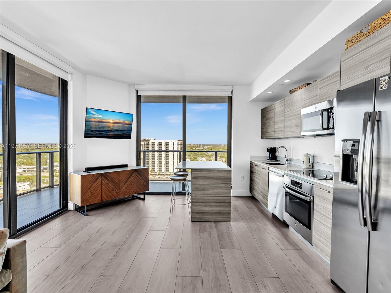 121 Northeast 34th Street, Unit 2016 Miami, FL 33137 - Photo 14 of 55 a kitchen with stainless steel appliances a refrigerator and a stove top oven