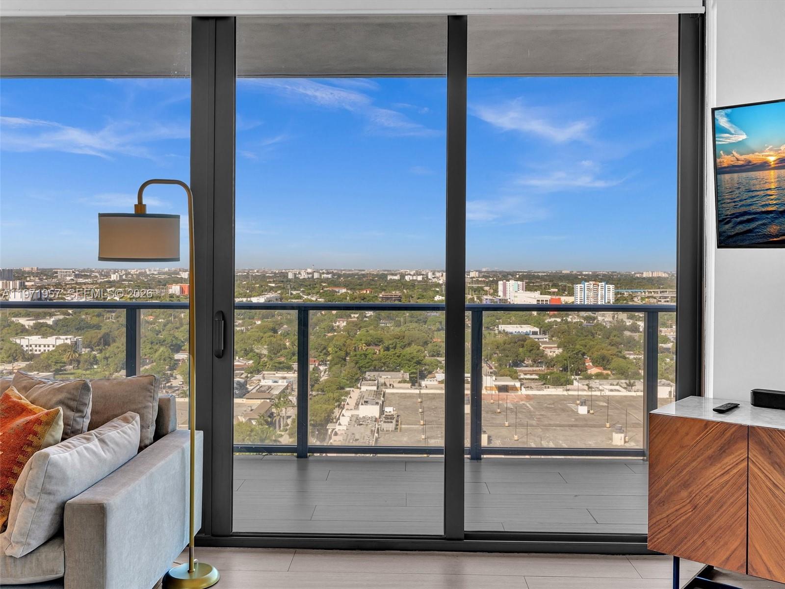 121 Northeast 34th Street, Unit 2016 Miami, FL 33137 - Photo 16 of 55 a view of a living room and floor to ceiling window or kitchen