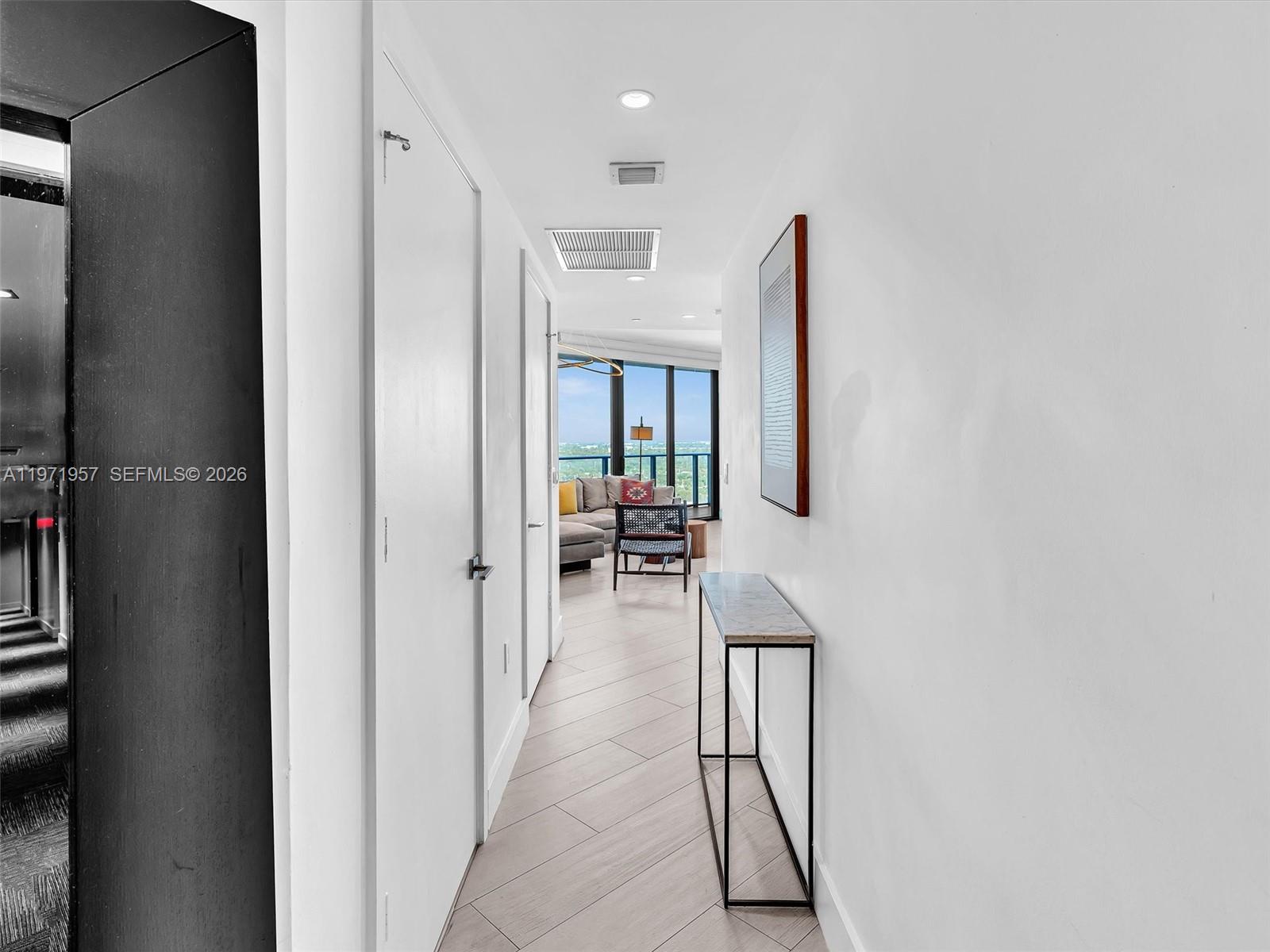 121 Northeast 34th Street, Unit 2016 Miami, FL 33137 - Photo 2 of 55 a hallway with a dining table and chairs