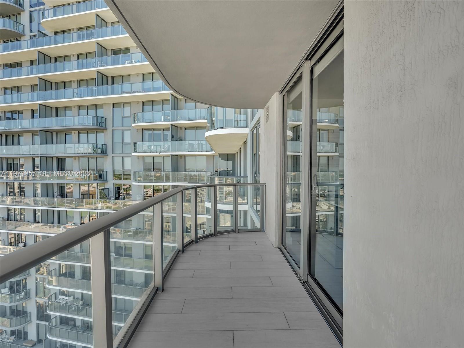 121 Northeast 34th Street, Unit 2016 Miami, FL 33137 - Photo 21 of 55 a view of staircase with white walls and a window