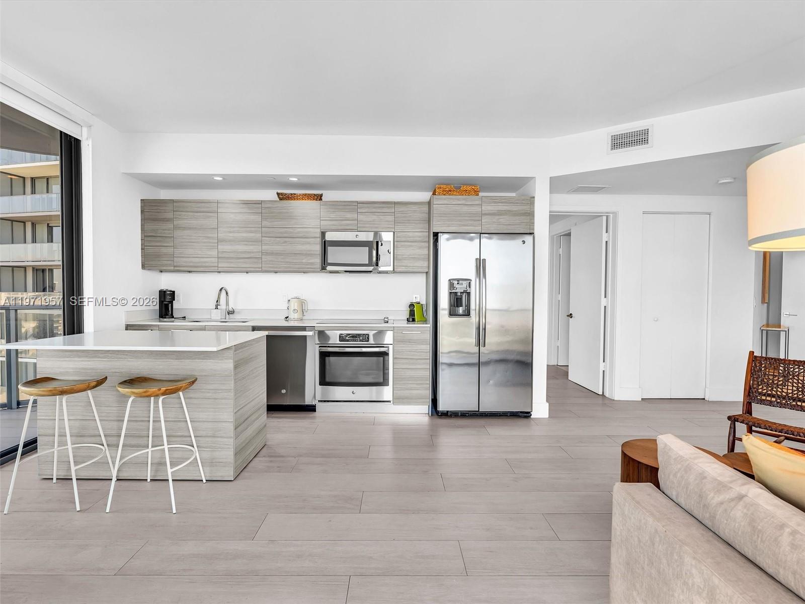 121 Northeast 34th Street, Unit 2016 Miami, FL 33137 - Photo 30 of 55 a kitchen with stainless steel appliances a stove a sink and a refrigerator