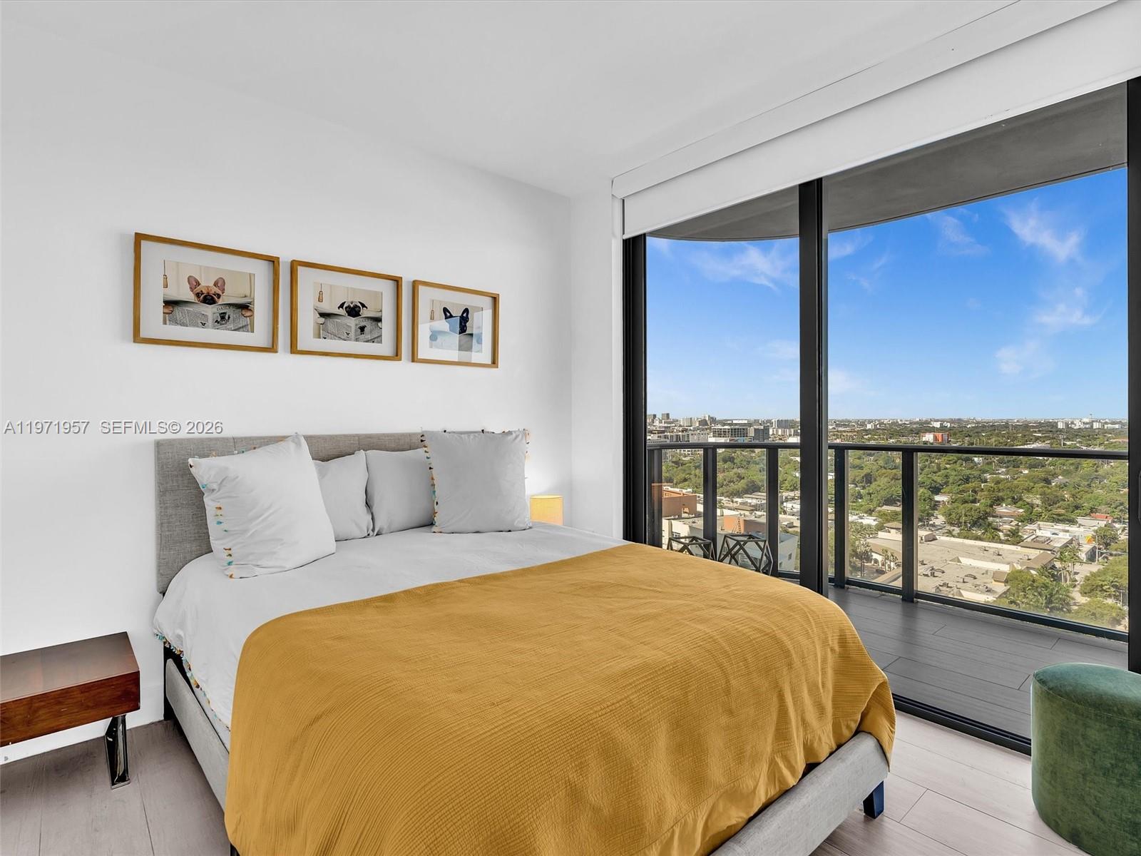 121 Northeast 34th Street, Unit 2016 Miami, FL 33137 - Photo 35 of 55 a bed sitting in a bedroom next to a large window