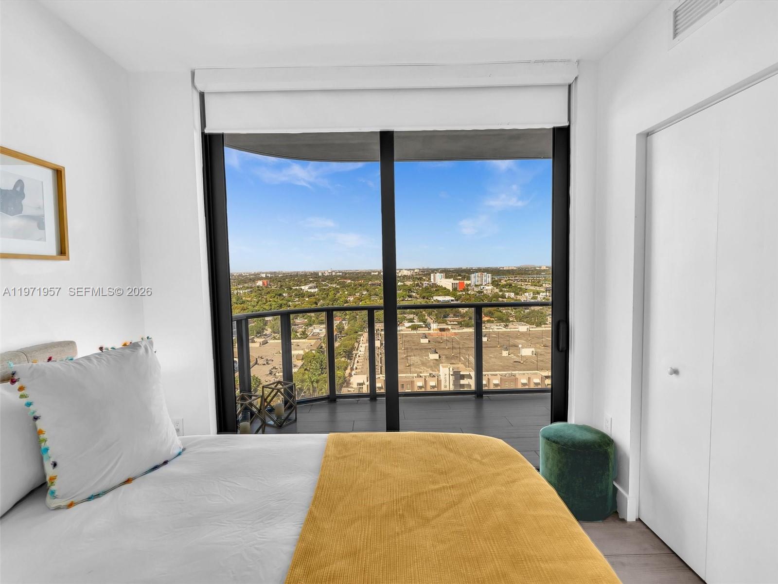 121 Northeast 34th Street, Unit 2016 Miami, FL 33137 - Photo 36 of 55 a bedroom with a bed and a large window