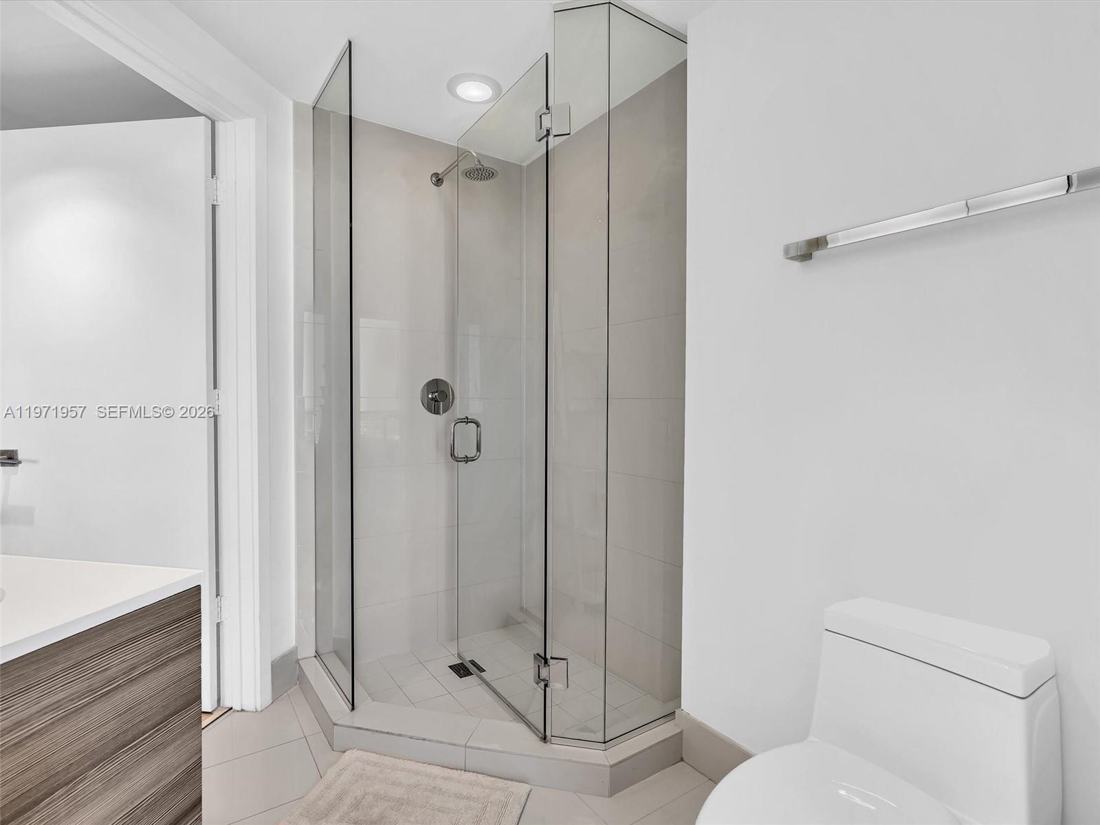 121 Northeast 34th Street, Unit 2016 Miami, FL 33137 - Photo 39 of 55 a bathroom with a shower and toilet