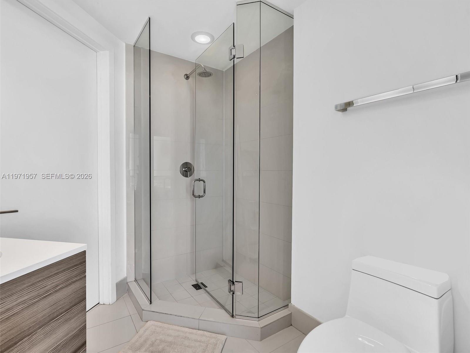 121 Northeast 34th Street, Unit 2016 Miami, FL 33137 - Photo 40 of 55 a bathroom with a shower a toilet and sink