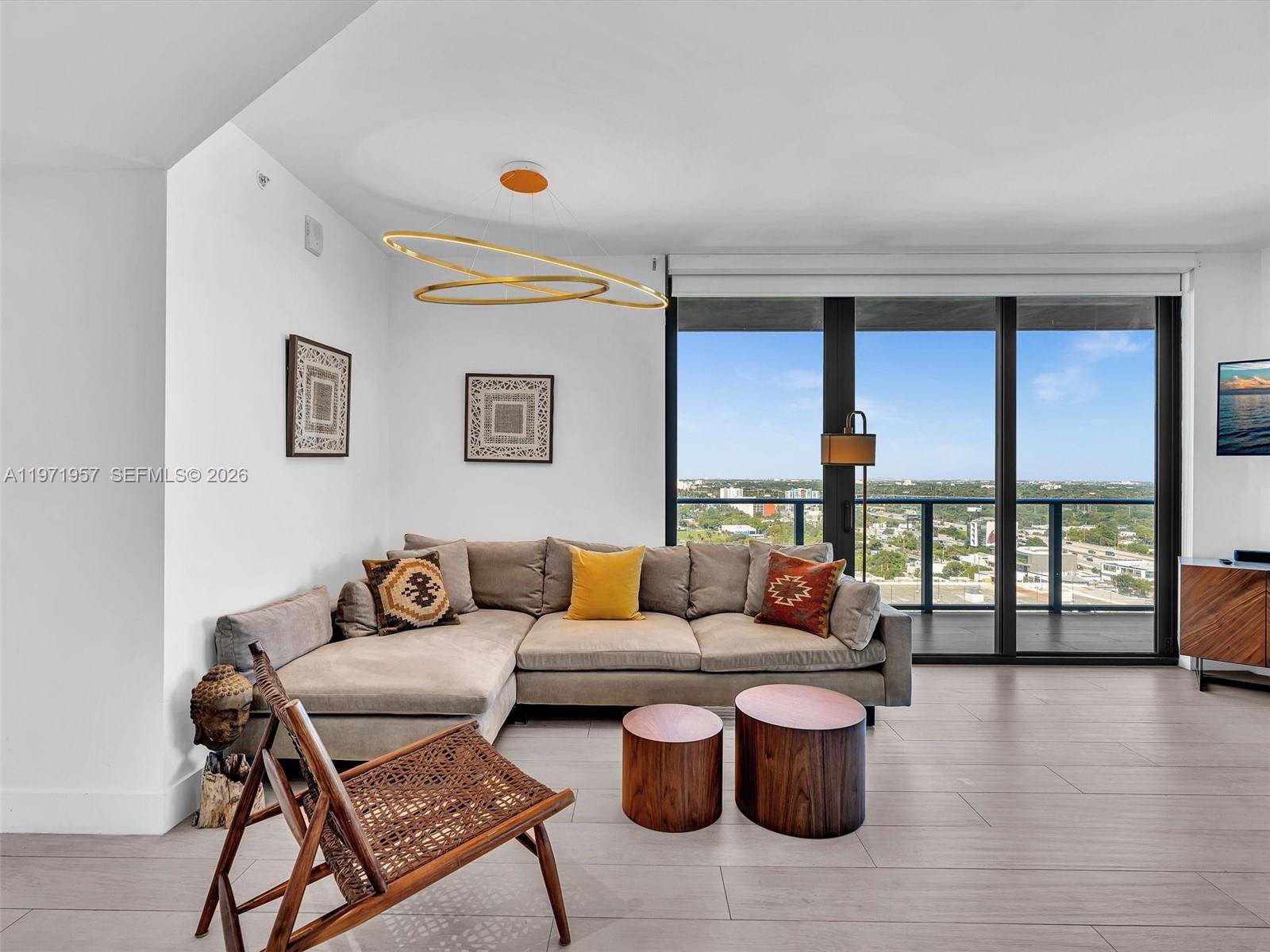 121 Northeast 34th Street, Unit 2016 Miami, FL 33137 - Photo 4 of 55 a living room with furniture and a large window