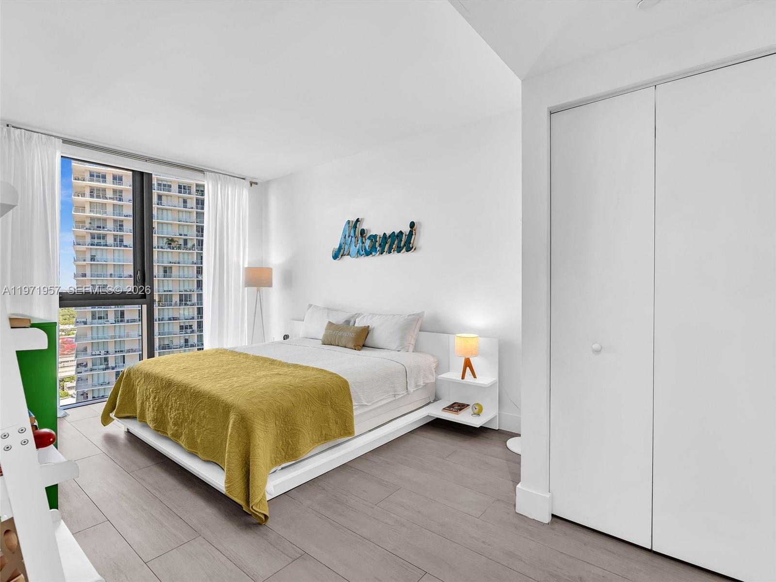 121 Northeast 34th Street, Unit 2016 Miami, FL 33137 - Photo 41 of 55 a bedroom with a bed and a window