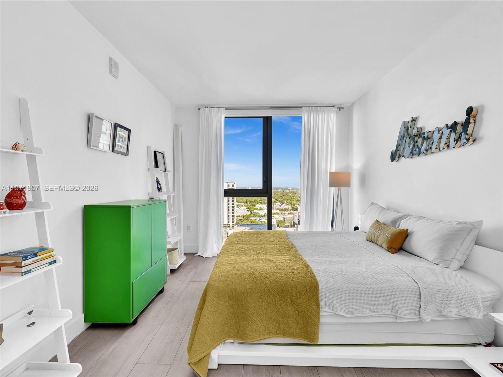 121 Northeast 34th Street, Unit 2016 Miami, FL 33137 - Photo 42 of 55 a bedroom with a bed and a window