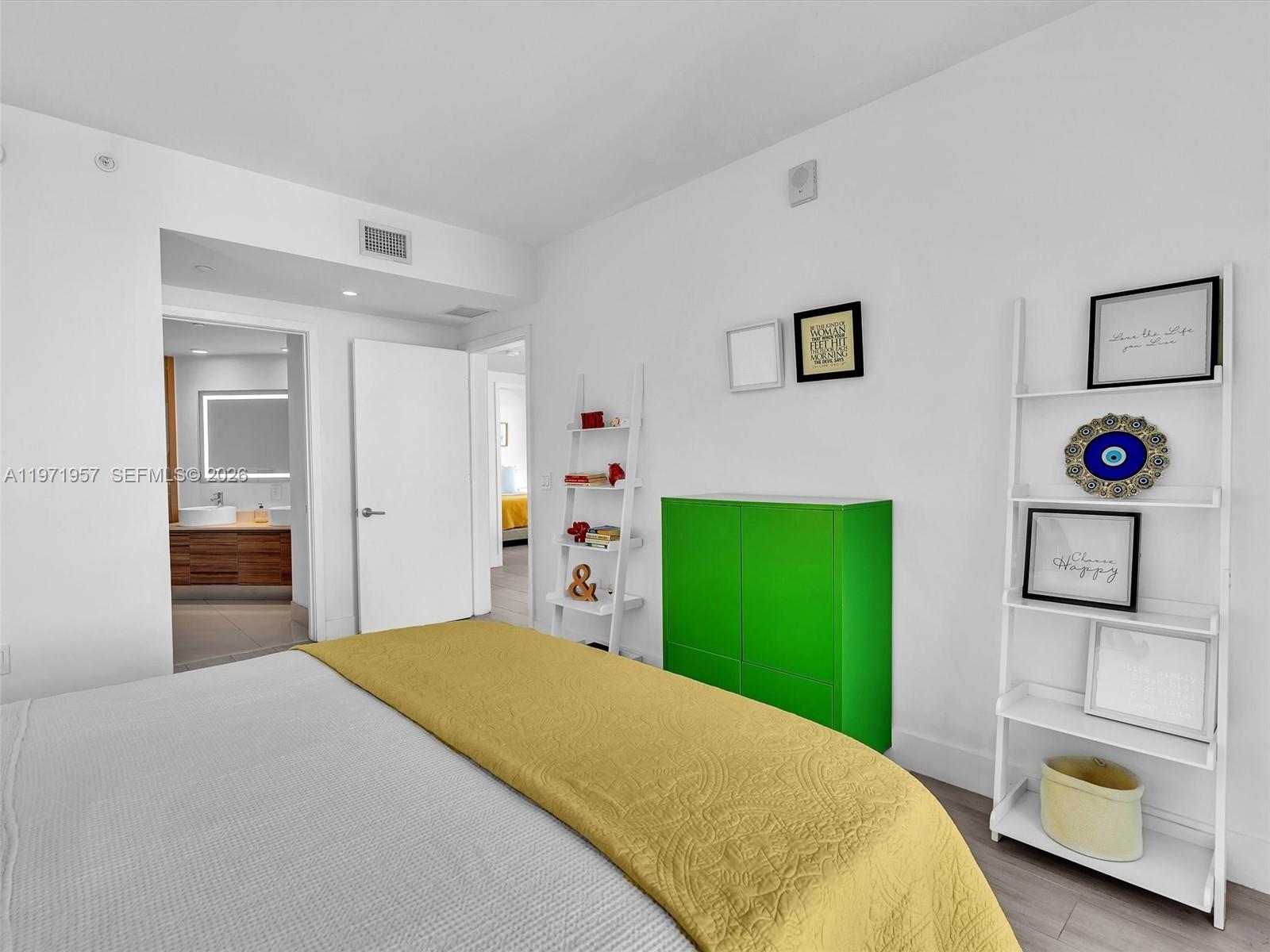 121 Northeast 34th Street, Unit 2016 Miami, FL 33137 - Photo 43 of 55 a bedroom with a bed and a view of living room