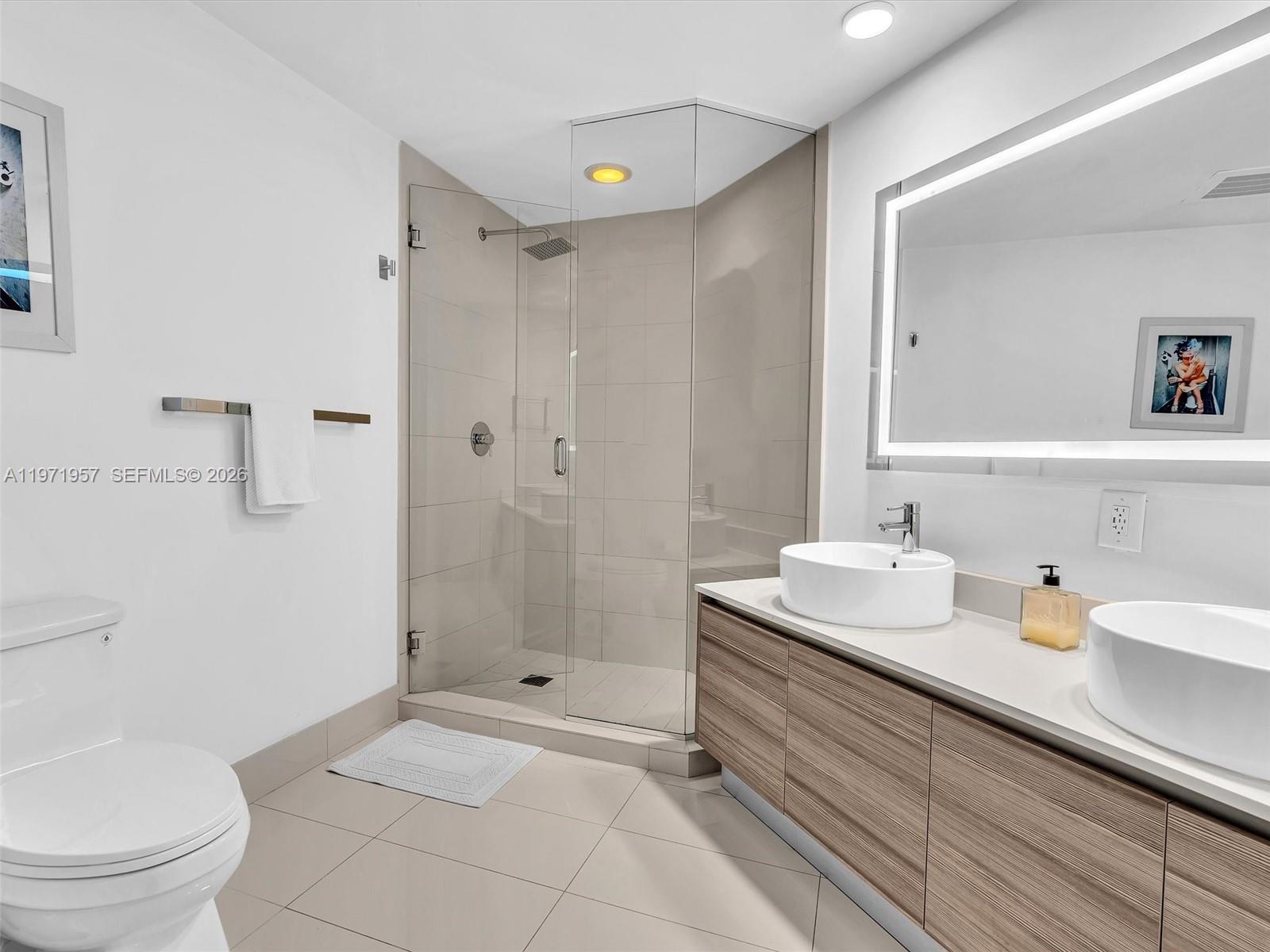 121 Northeast 34th Street, Unit 2016 Miami, FL 33137 - Photo 46 of 55 a bathroom with a sink a toilet and shower