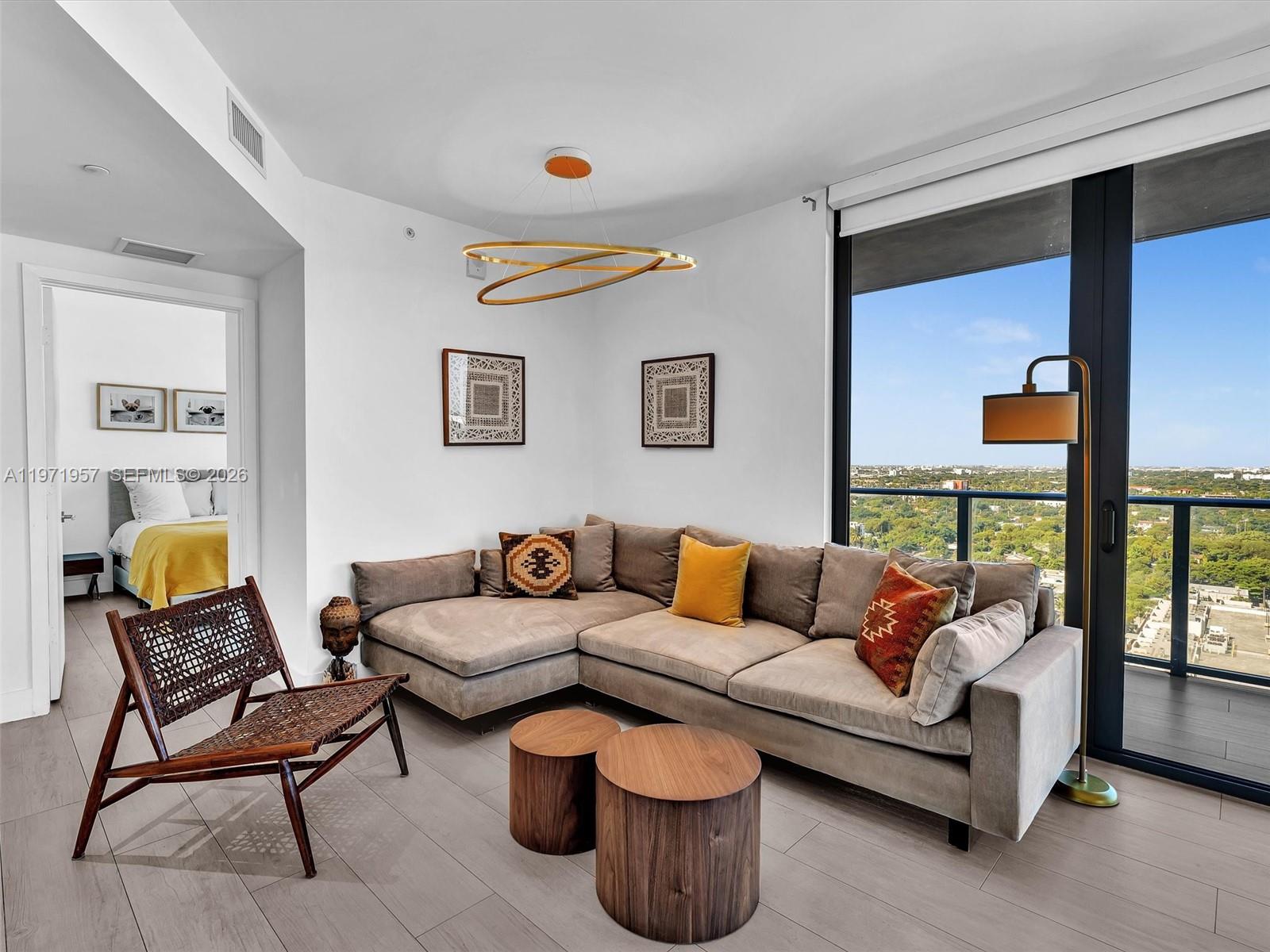 121 Northeast 34th Street, Unit 2016 Miami, FL 33137 - Photo 5 of 55 a living room with furniture and a potted plant