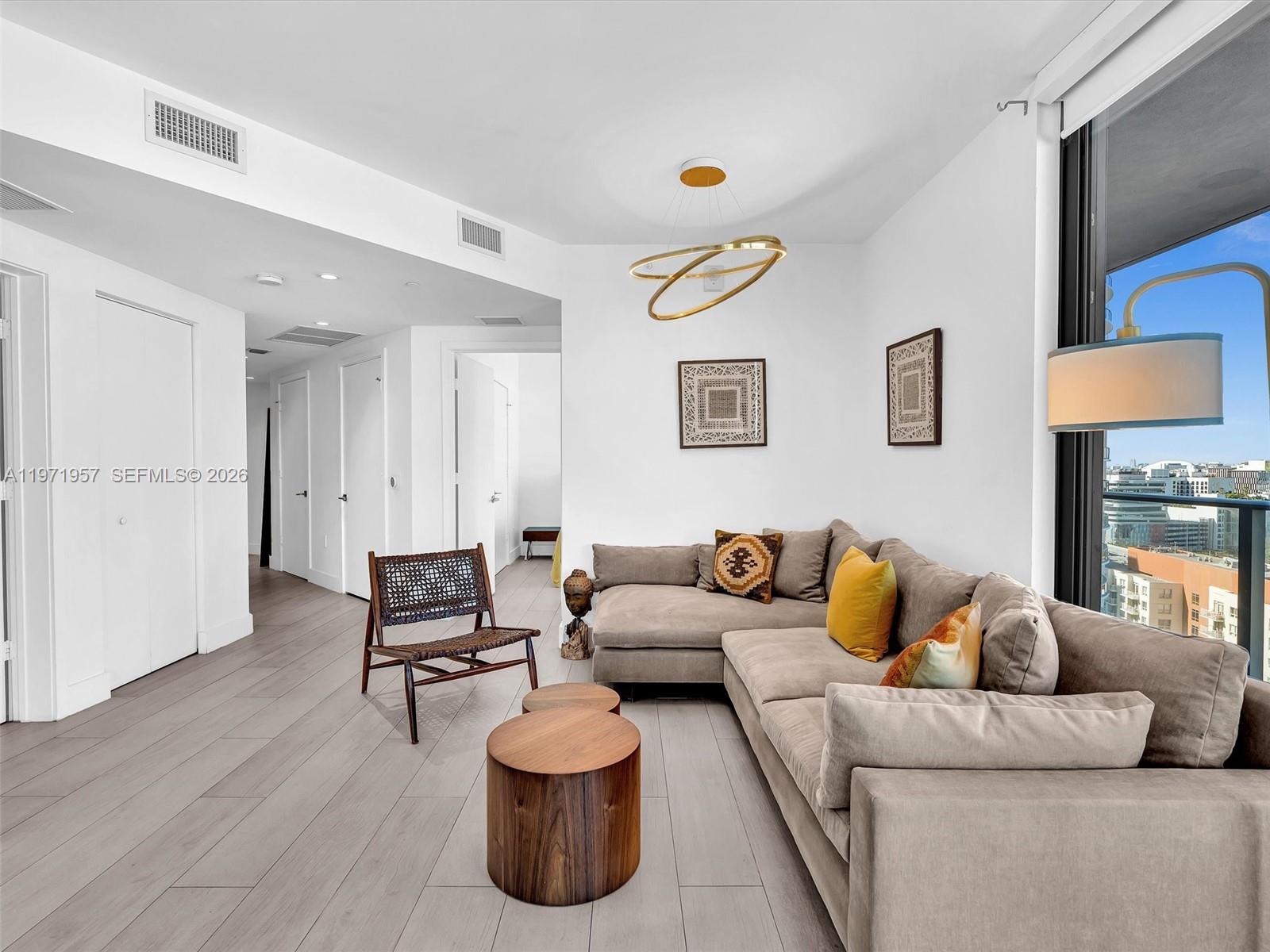 121 Northeast 34th Street, Unit 2016 Miami, FL 33137 - Photo 6 of 55 a living room with furniture and a lamp