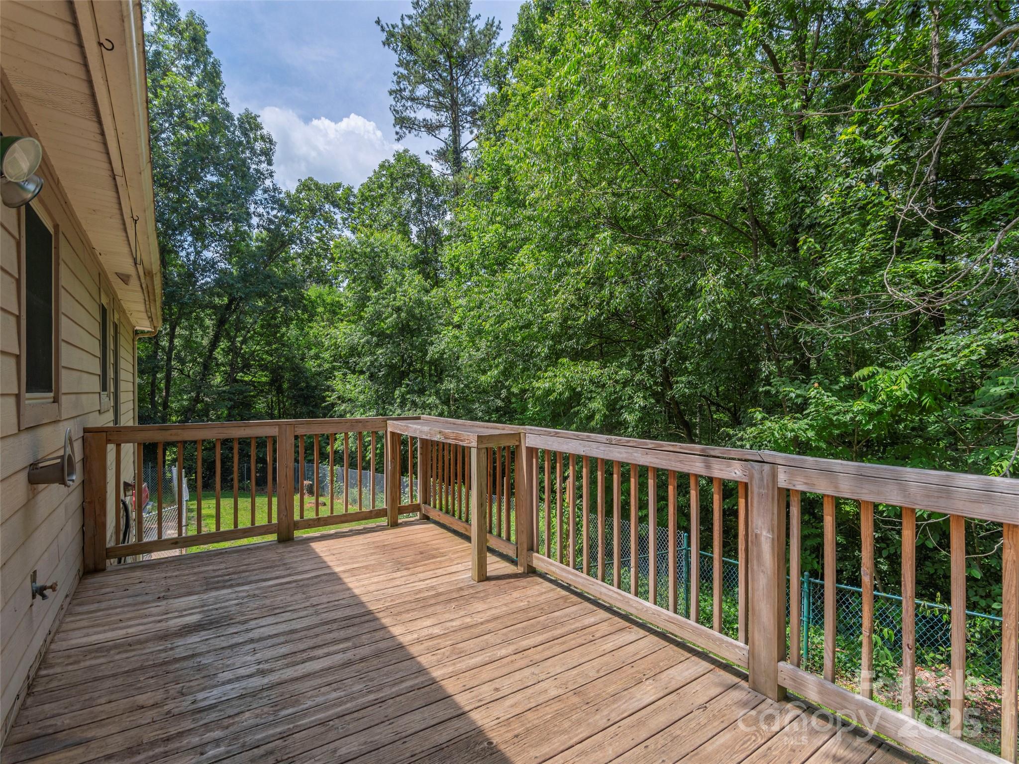 623 Nellie John Drive Clyde, NC 28721 - Photo 18 of 25 a balcony with wooden floor and fence
