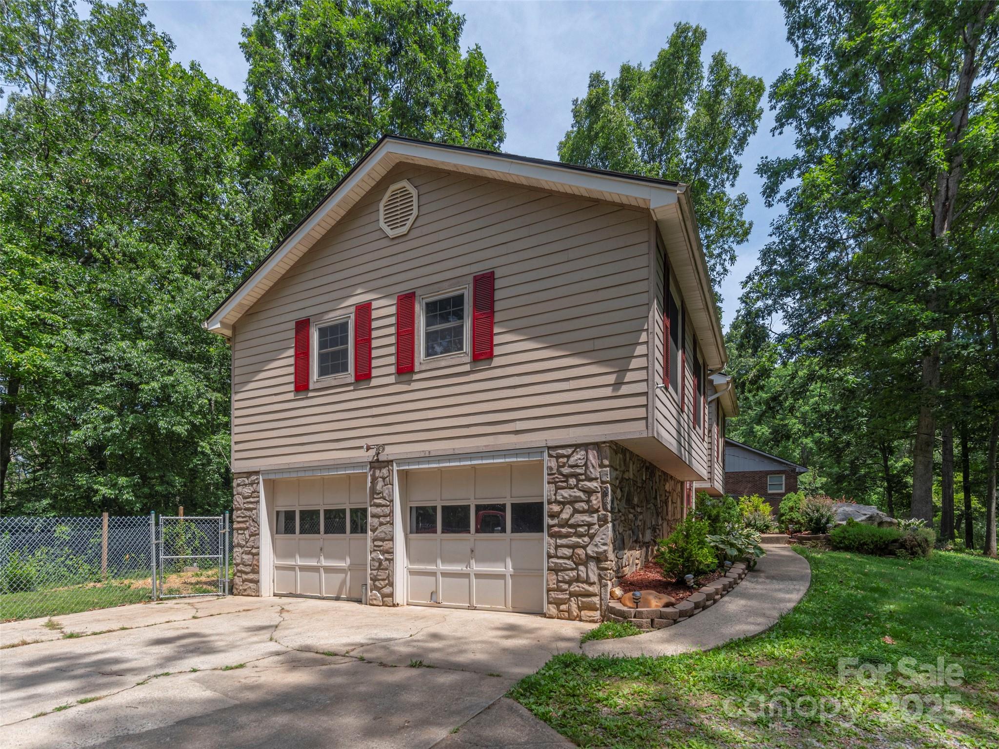 623 Nellie John Drive Clyde, NC 28721 - Photo 23 of 25 a front view of a house with a garden