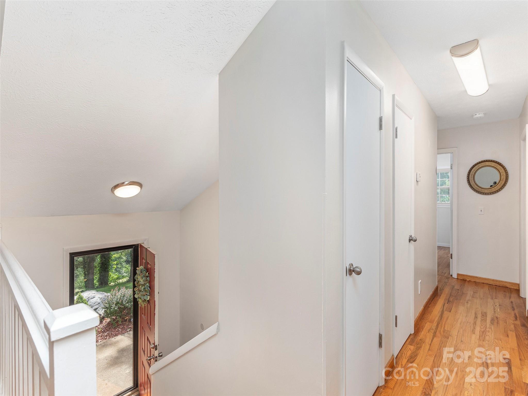 623 Nellie John Drive Clyde, NC 28721 - Photo 5 of 25 a view of a hallway with bathroom and wooden floor