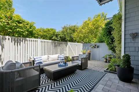 a view of a patio with couches and potted plants