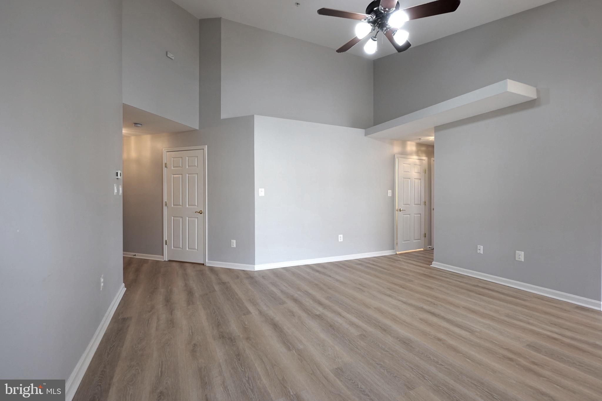 2502 Hemingway Drive, Unit 23B Frederick, MD 21702 - Photo 11 of 30 a view of an empty room with a chandelier fan